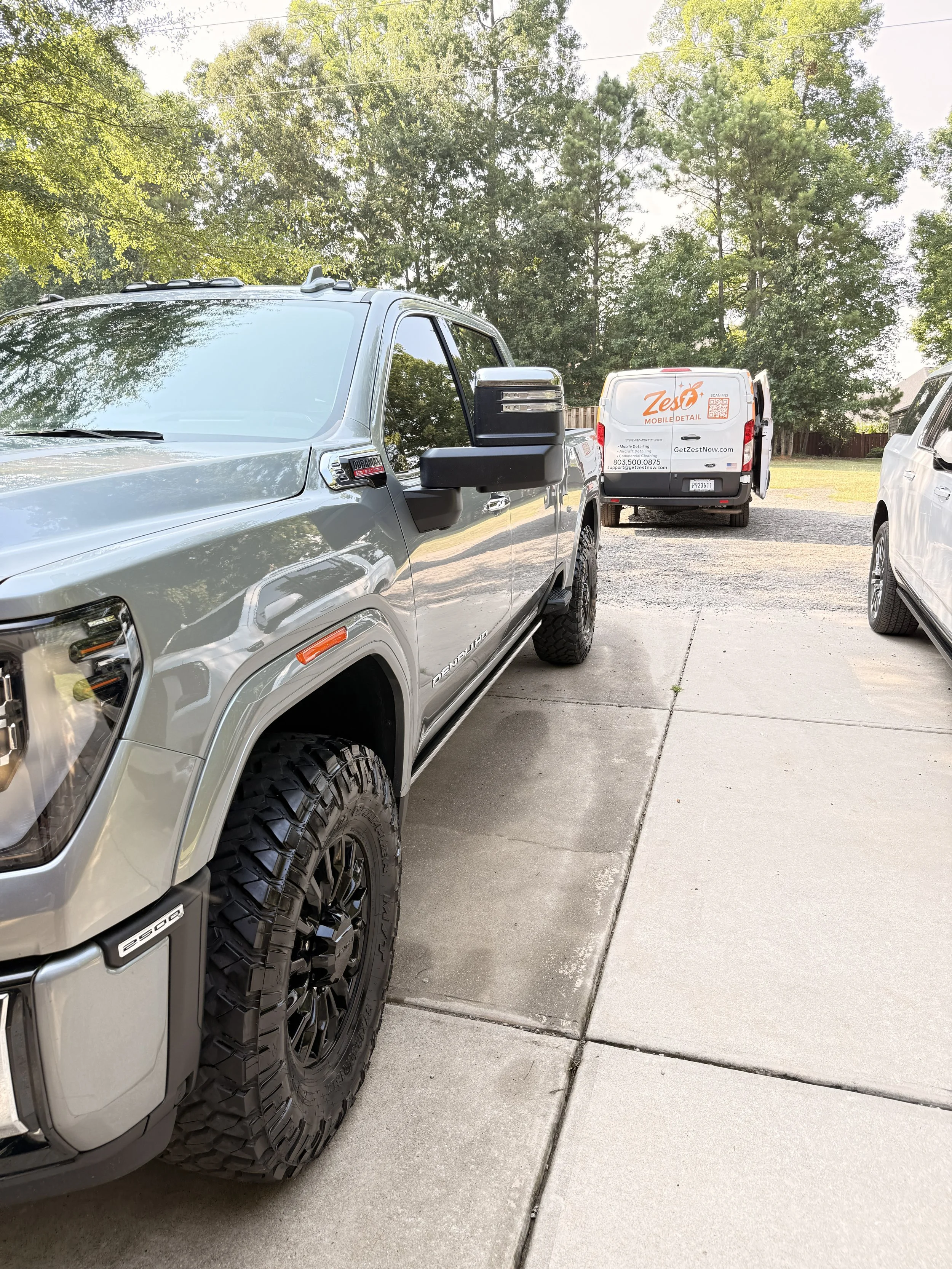 Zest Mobile Detail service van beside a freshly detailed GMC Sierra 2500 in Irmo, SC.