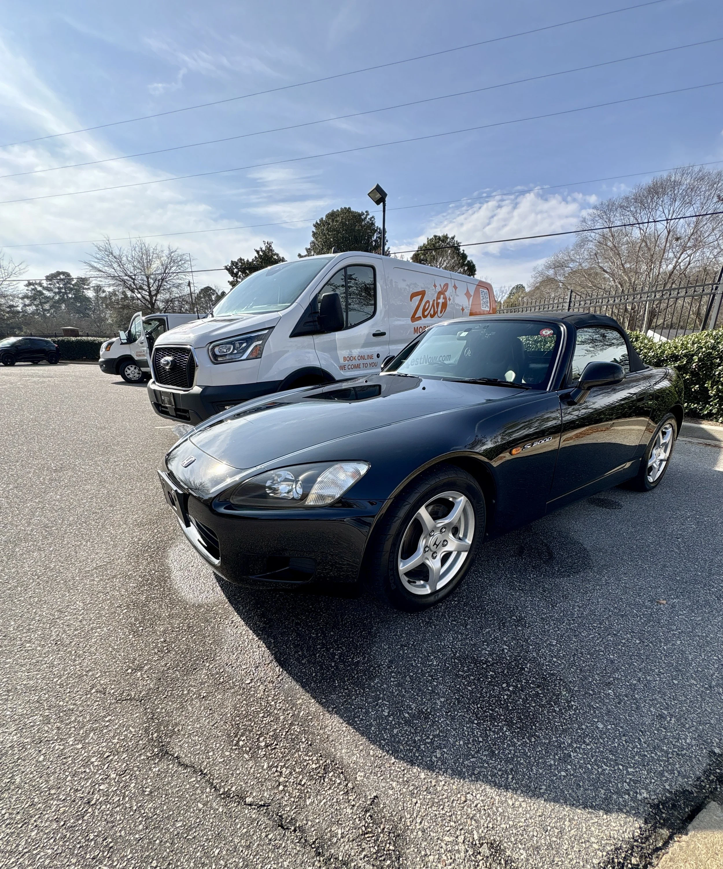 Black Honda S2000 professionally detailed by Zest Mobile Detailing next to service van in Columbia South Carolina