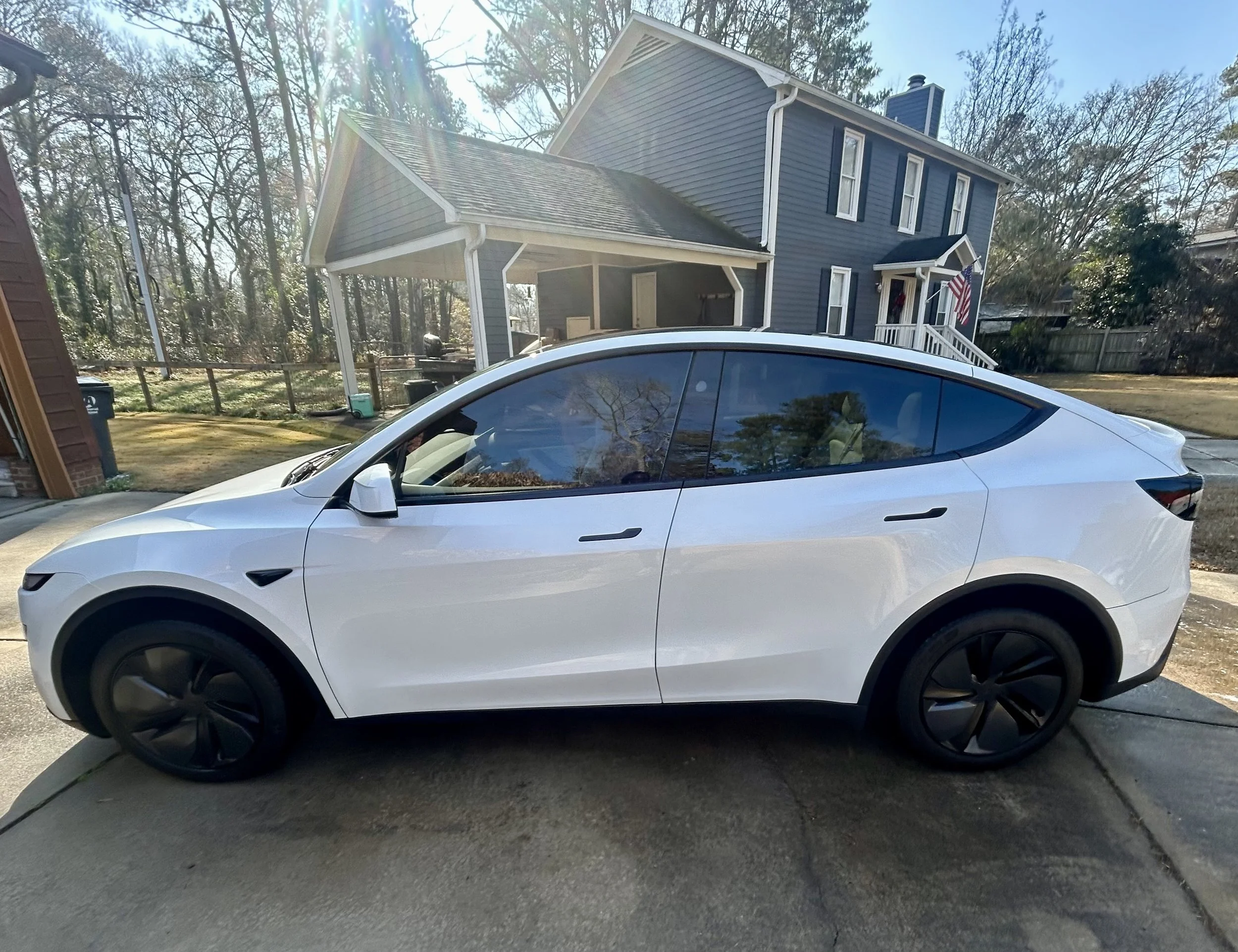 White Tesla Model Y professionally detailed by mobile car detailing service at a residential driveway in Columbia SC