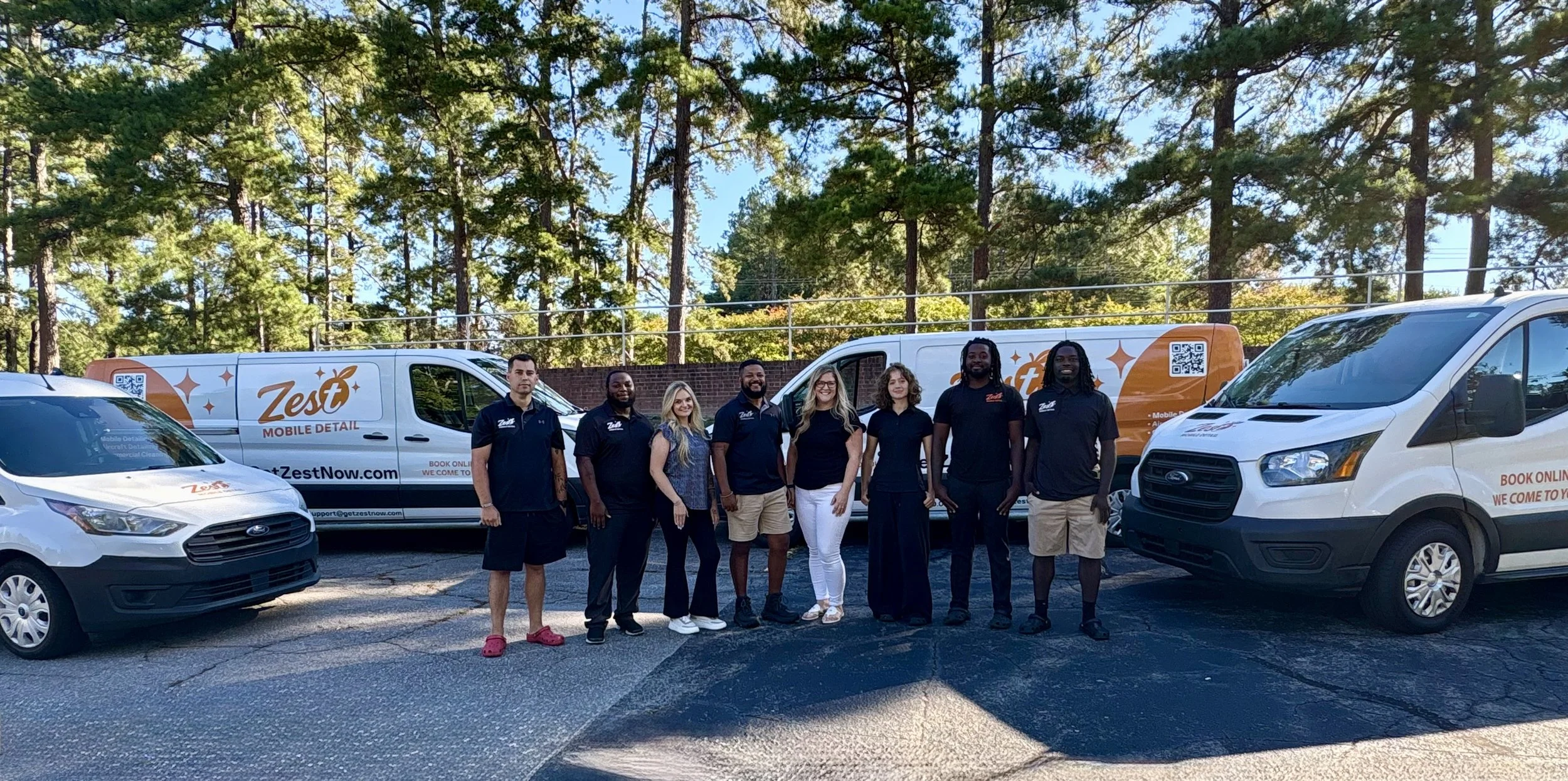 Zest Mobile Detail professional team standing in front of branded mobile car detailing vans serving Columbia, Lexington and surrounding South Carolina Midlands communities.