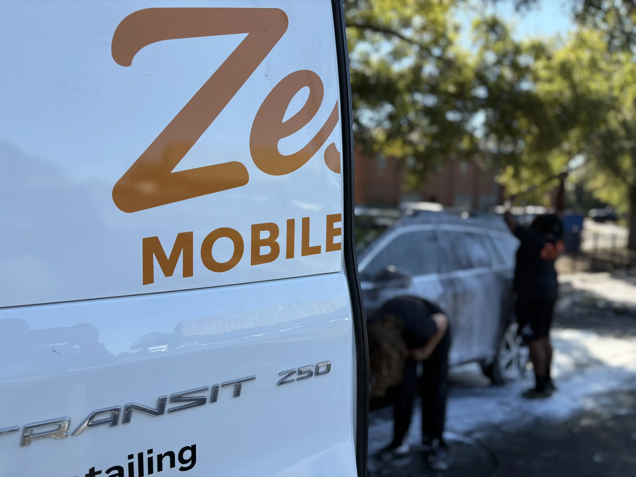 Zest Mobile Detail van with a technician hand-washing a car in Columbia, SC