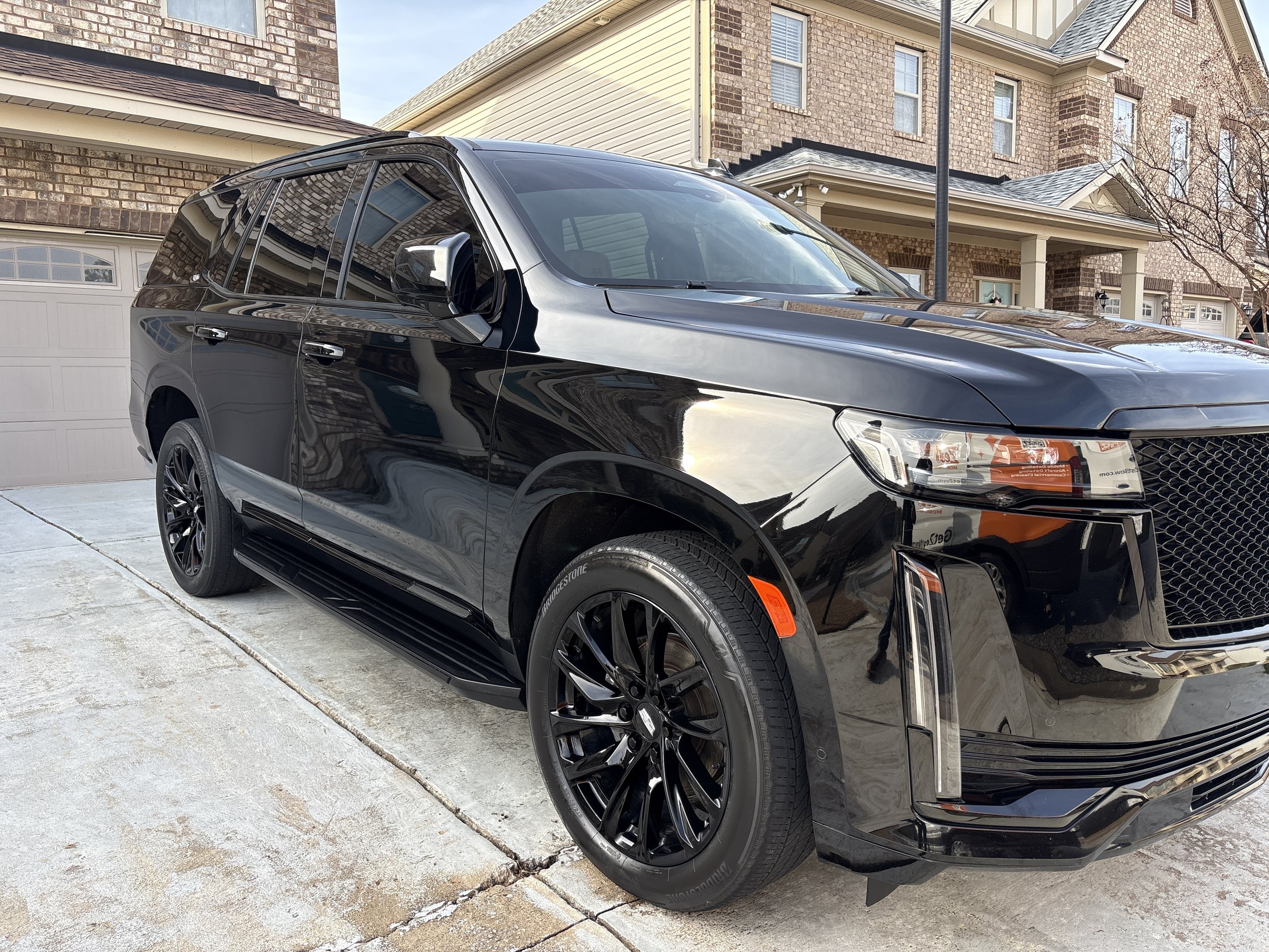Black Cadillac Escalade receiving a full paint polish, interior deep cleaning, and exterior detail by Zest Mobile Detailing in Lexington, SC. Luxury SUV mobile car detailing service restoring gloss, shine, and cleanliness with professional paint corr