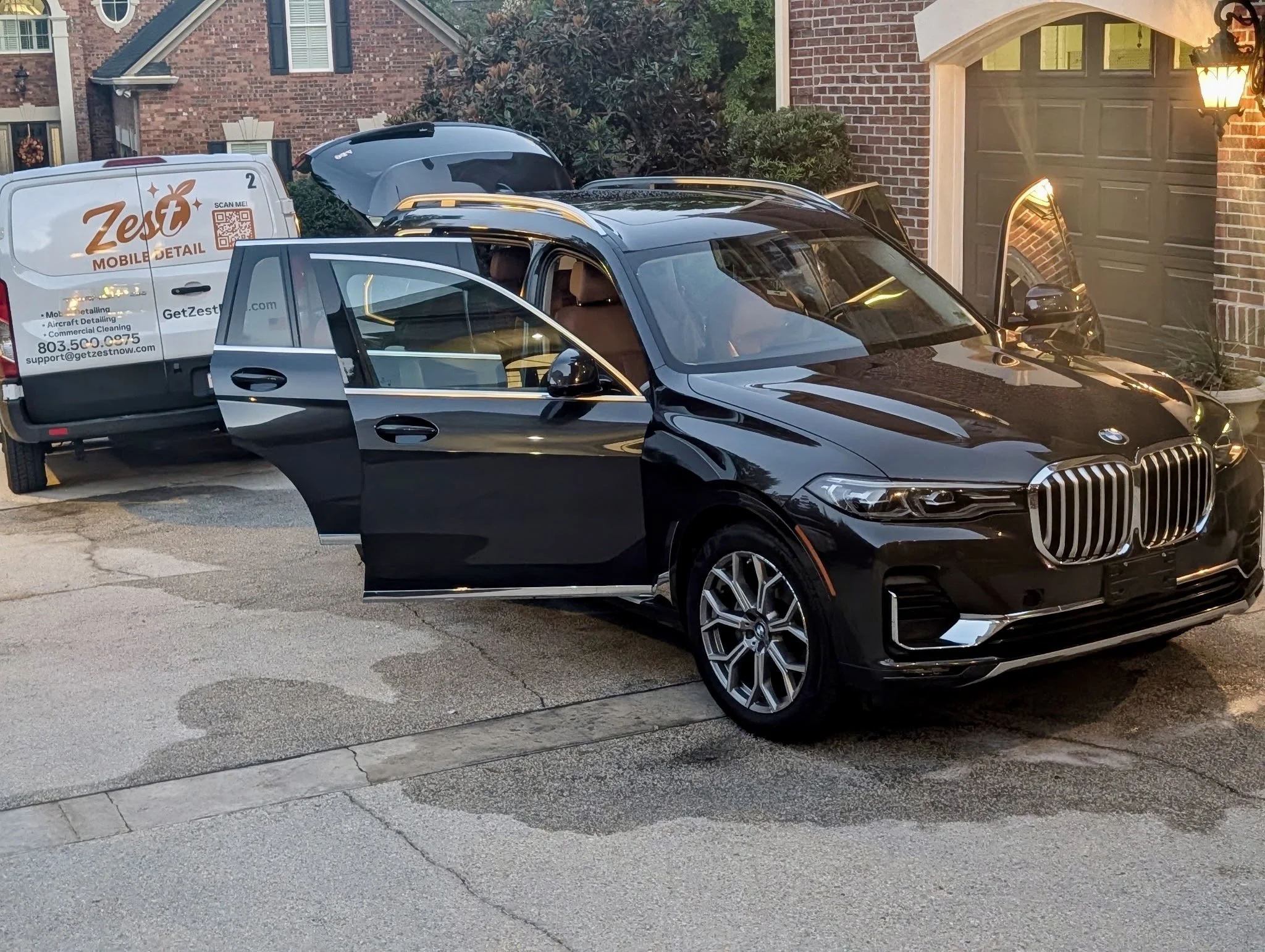 Zest Mobile Detail van parked behind a BMW X7 being detailed in a driveway in Lexington, SC