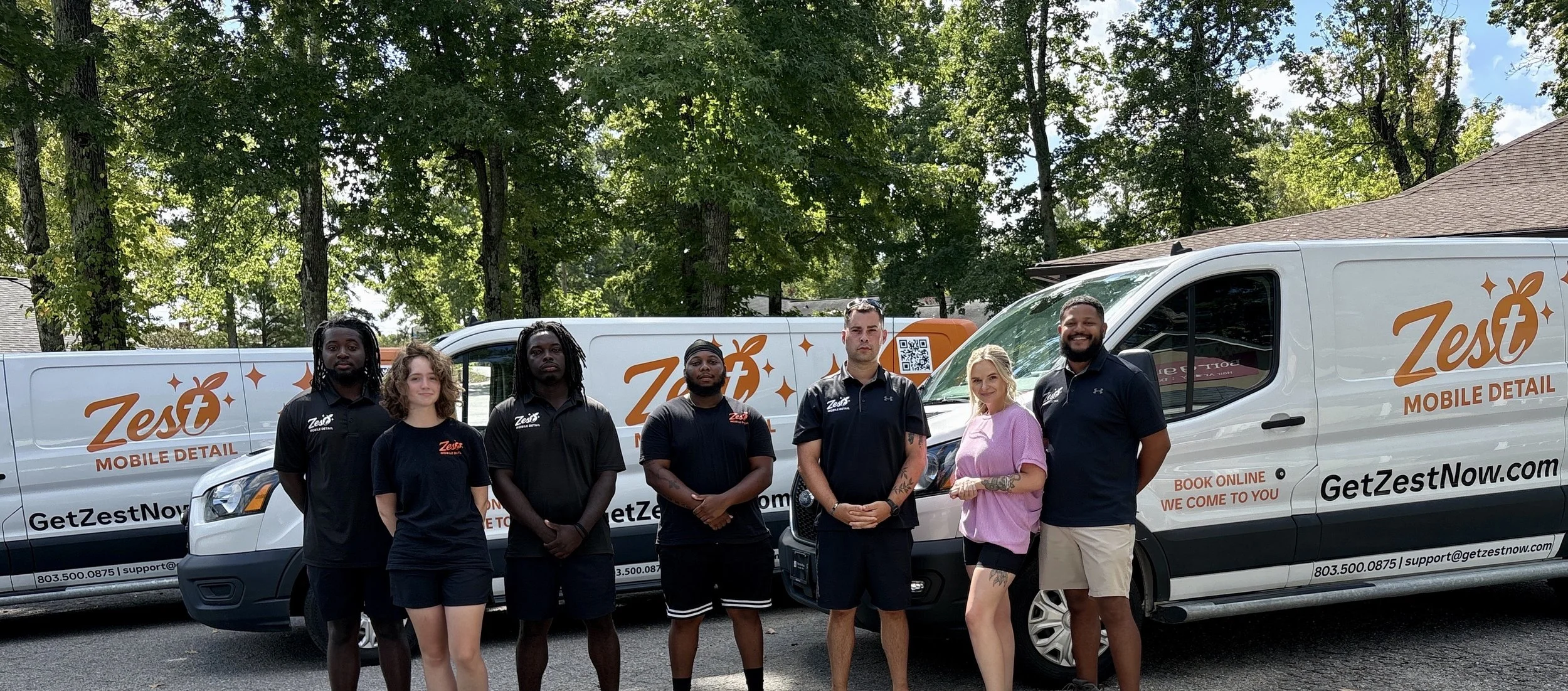 Zest Mobile Detail team standing beside branded mobile detailing vans serving Columbia, Lexington, Chapin, Irmo and the South Carolina Midlands.