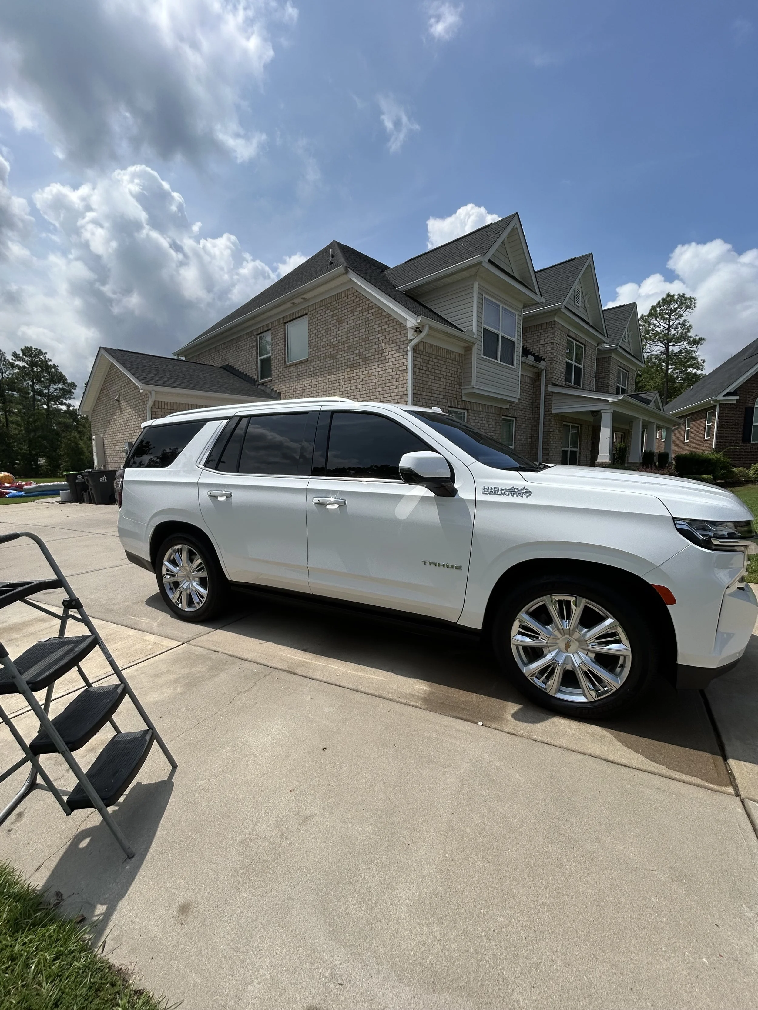 Glossy white Chevrolet Tahoe after professional mobile car detailing by Zest Mobile Detail in Columbia, South Carolina.