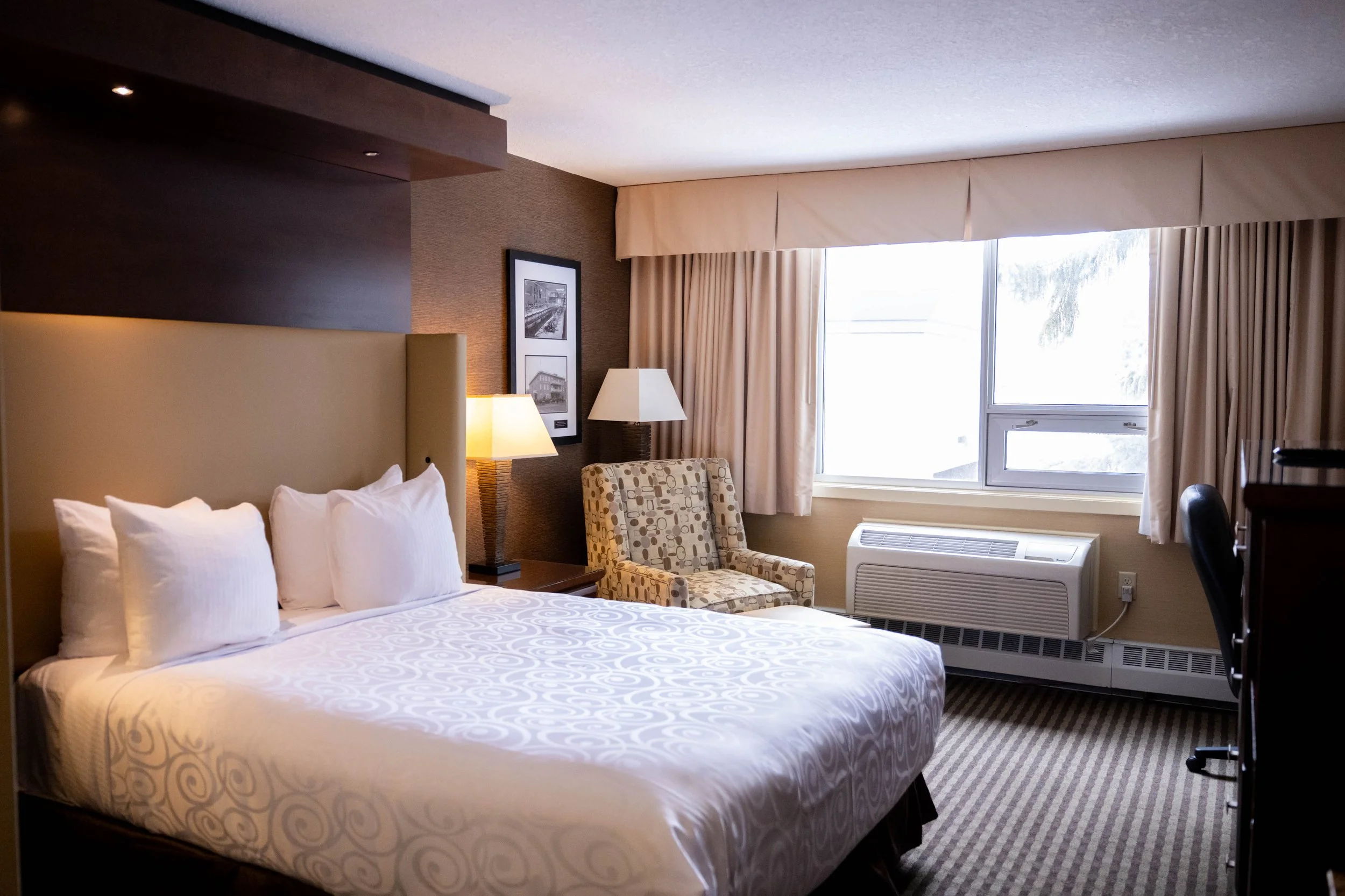 Sing Queen Deluxe room. Comfortable for solo stays or couples at Best Western Premier Denham Inn & Suites near Edmonton International Airport
