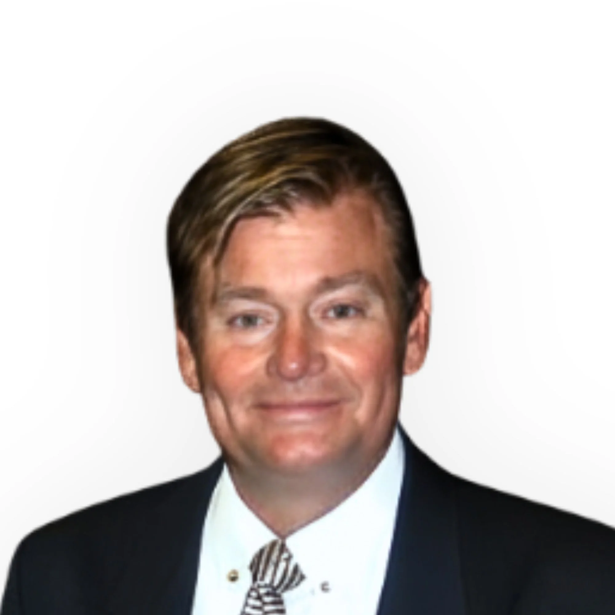 A professionally dressed man with brown hair smiling against a plain white background.