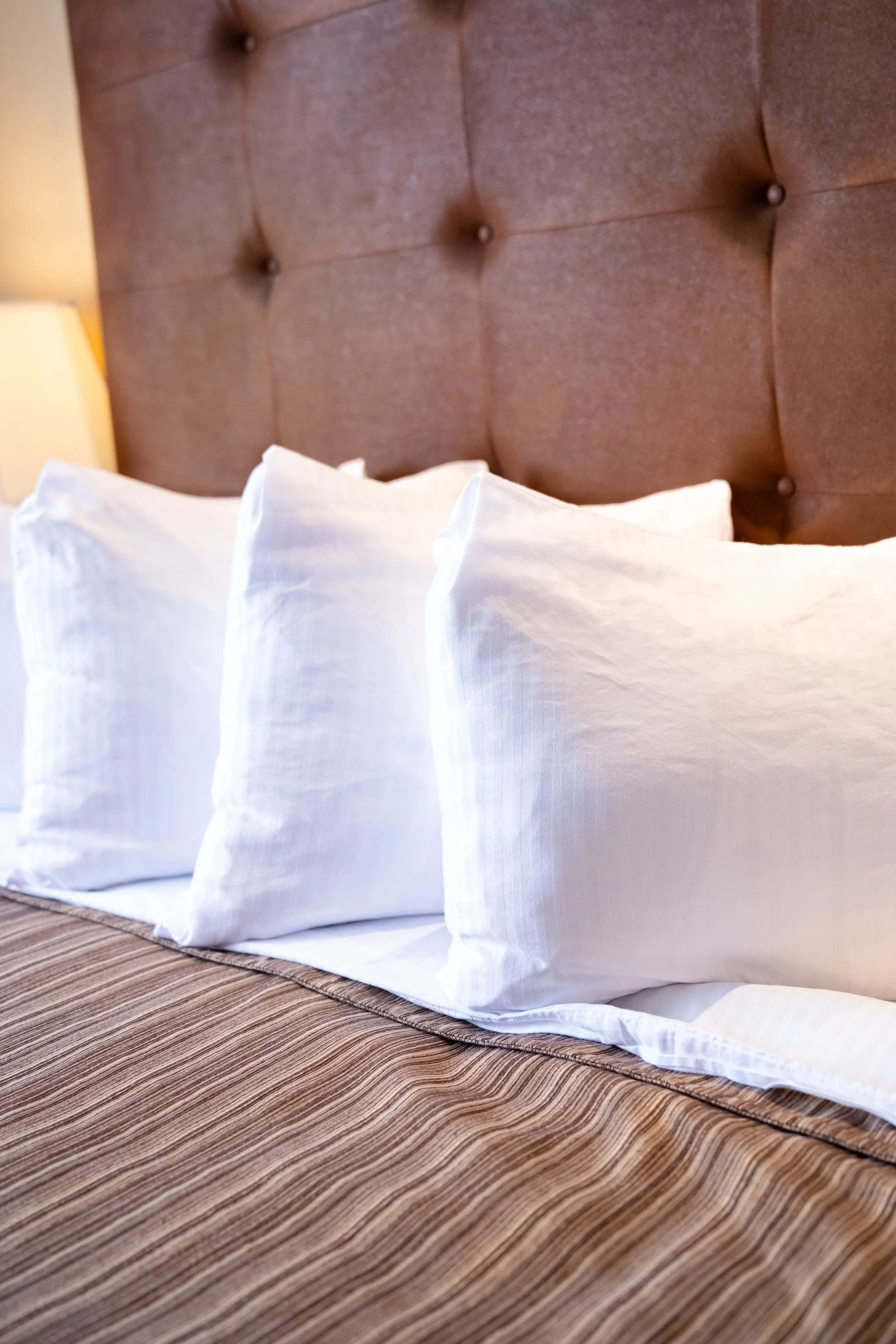 Clean room with a comfortable bed at Denham Inn & Suites in Leduc Alberta 