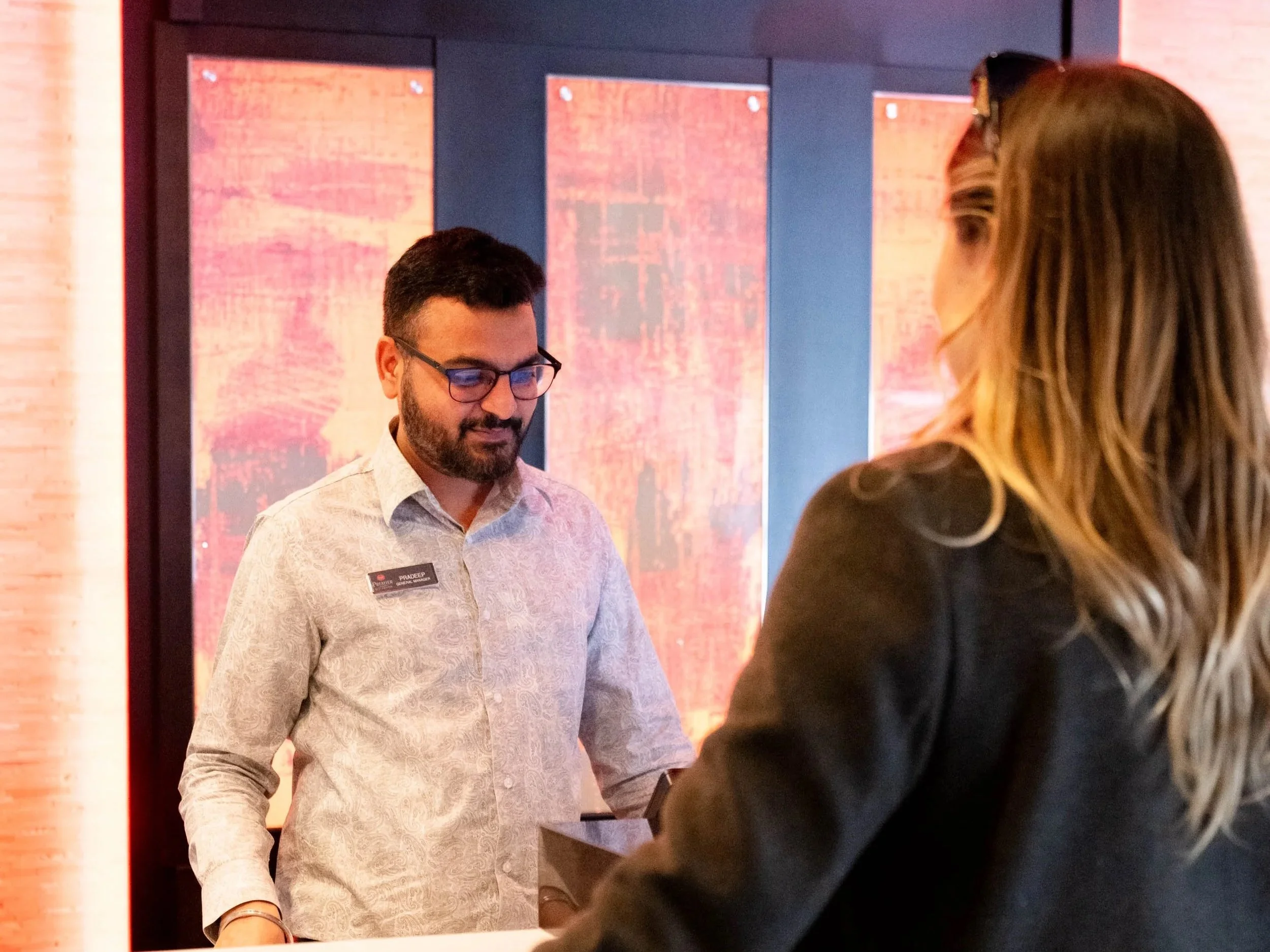 Friendly staff helping a guest check in Best Western Premier Denham Inn & Suites in Leduc, Alberta. Near Edmonton International Airport
