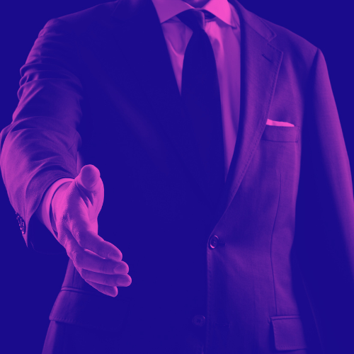 A man in a business suit reaching out his hand as if to shake yours