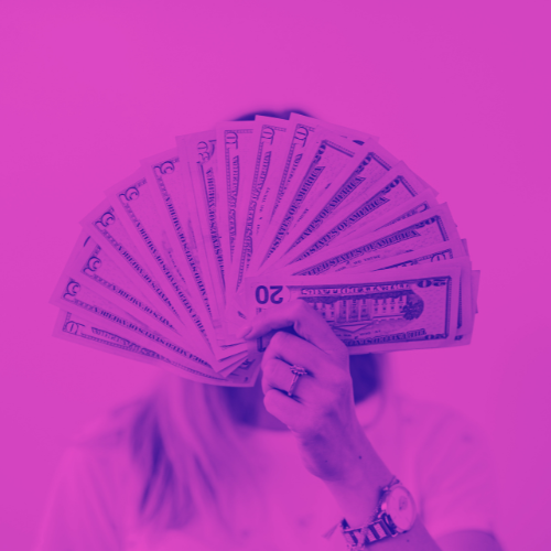 A woman holding fanned out dollar bills