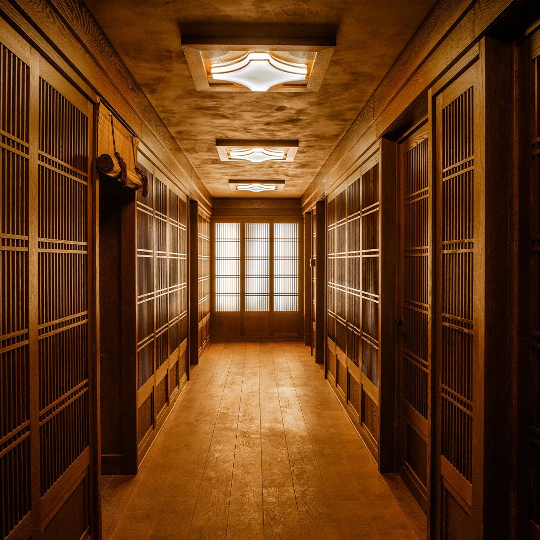 Wood-paneled hallway with shoji sliding doors and modern ceiling lights.