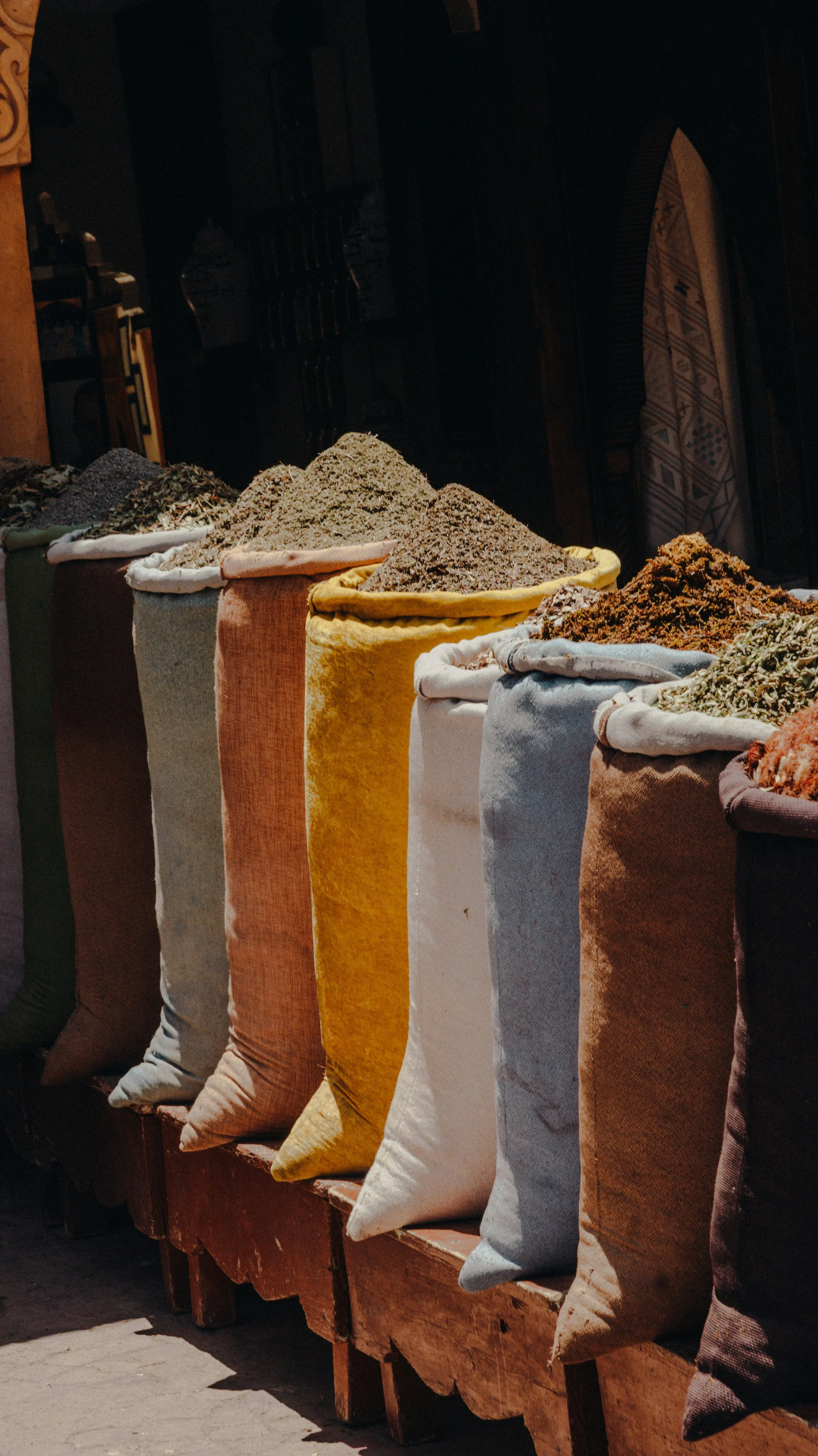 Colorful bags of spices on display in a market
