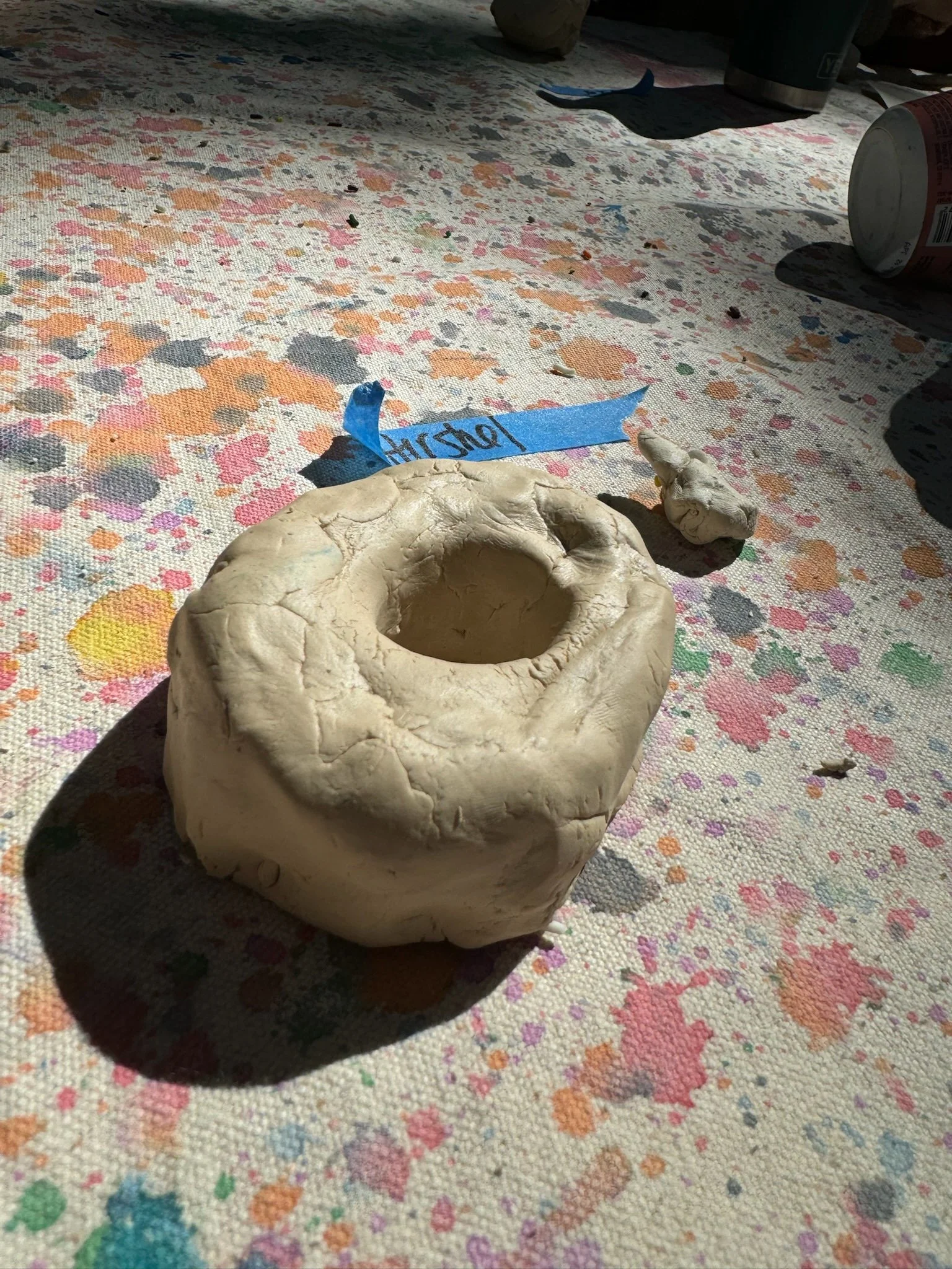 A raw clay donut sculpture.