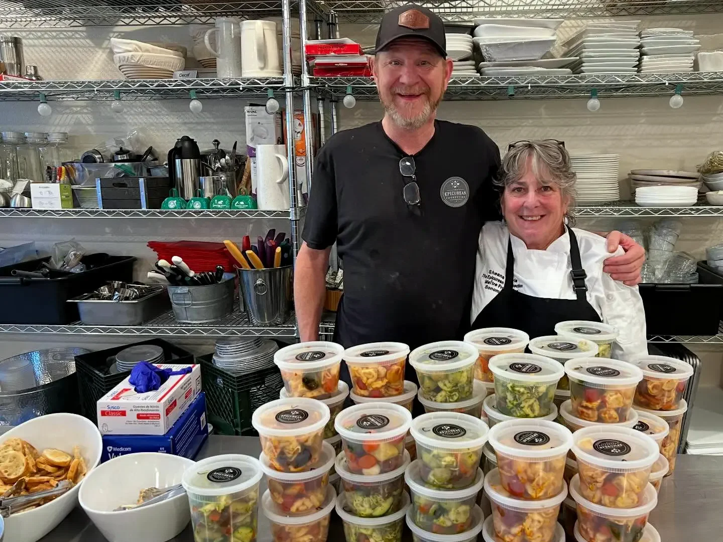 Ben Session and Sheana Davis with stacks of meals to go