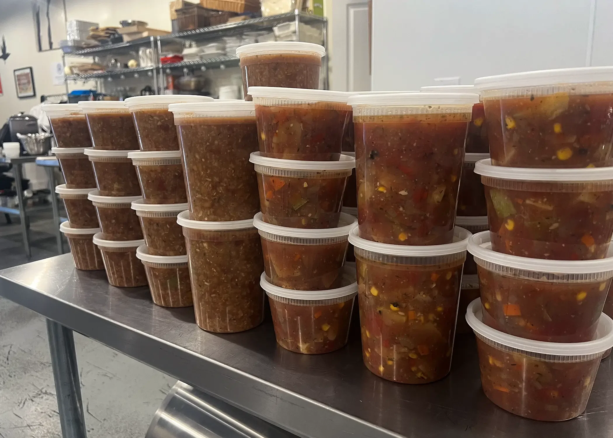 Stacked to-go containers of minestrone soup