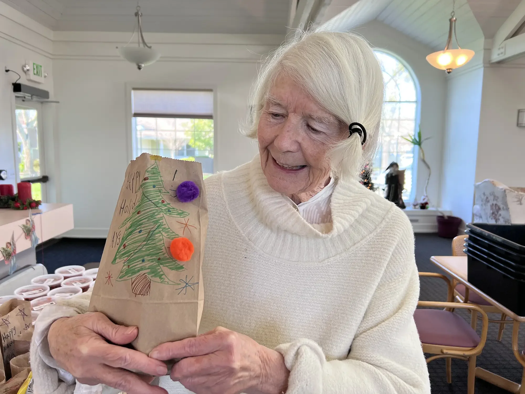 Senior resident Joanna with a holiday gift bag