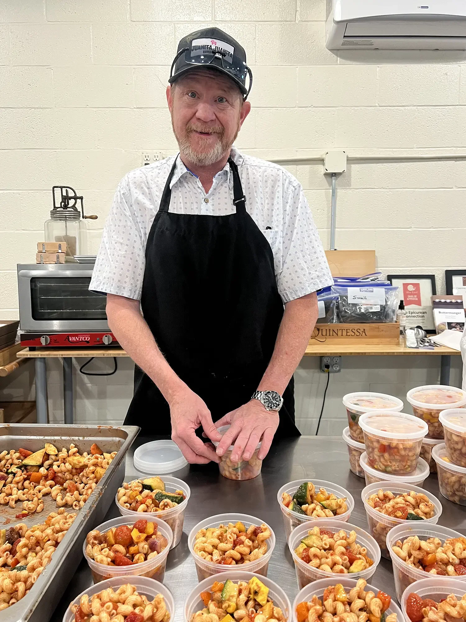 Ben Sessions packages up meals to go for No Pay Cafe 