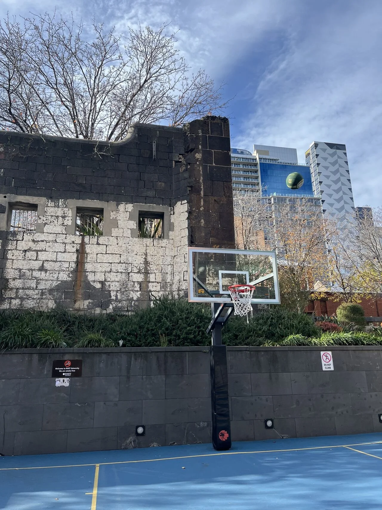 A basketball flying through the air toward a hoop