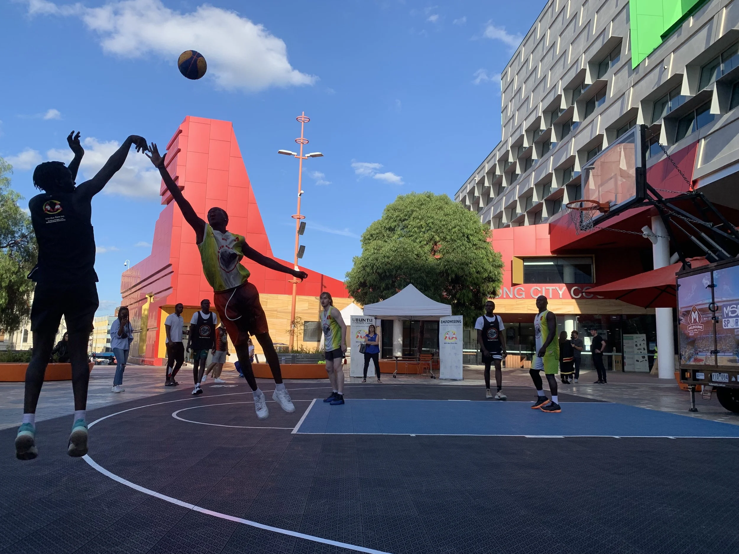 A group of people playing basketball