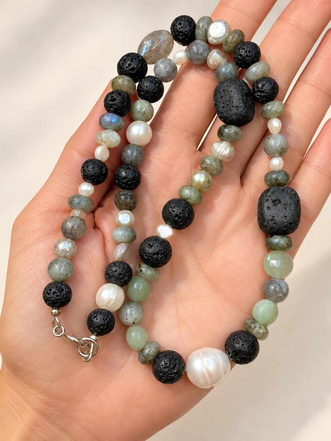 Lava Stone and Pearl Necklace in Hand.png