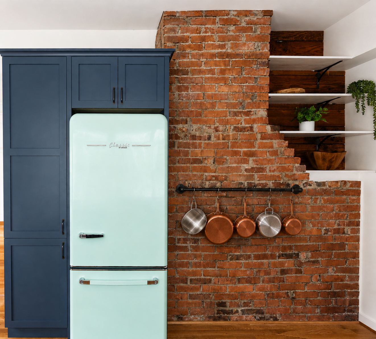 Teal cabinetry beside exposed original brick fireplace and mint refrigerator, Craftsman home renovation