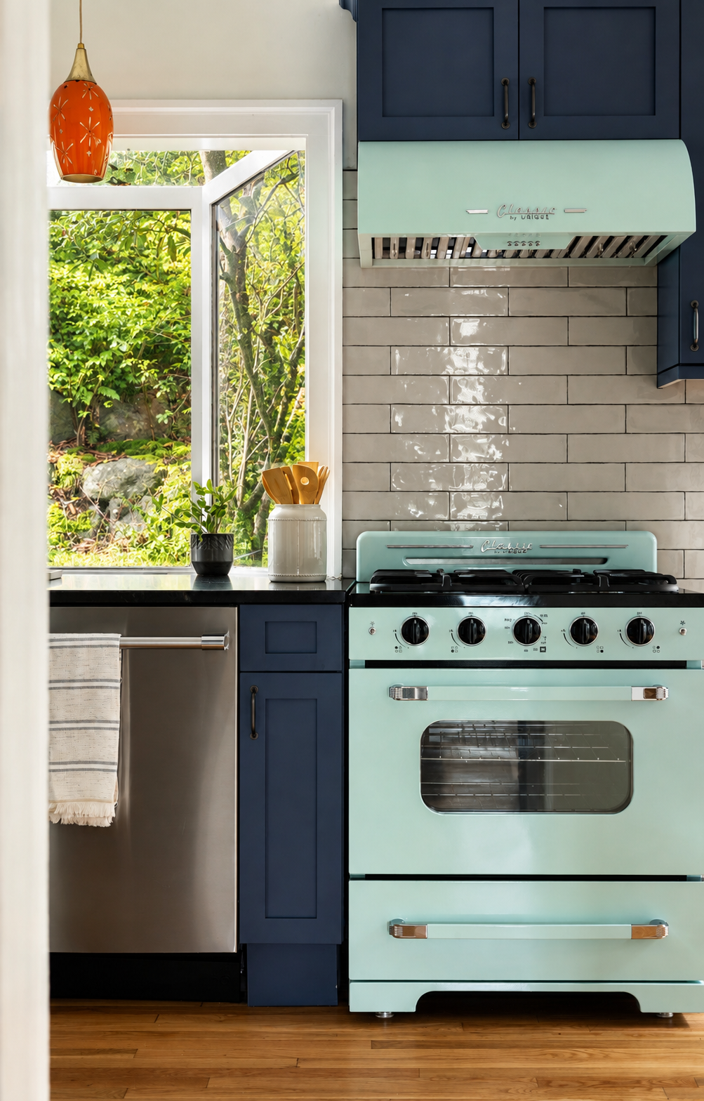 Teal kitchen cabinets and original hardwood flooring in 1905 Craftsman kitchen, Seattle