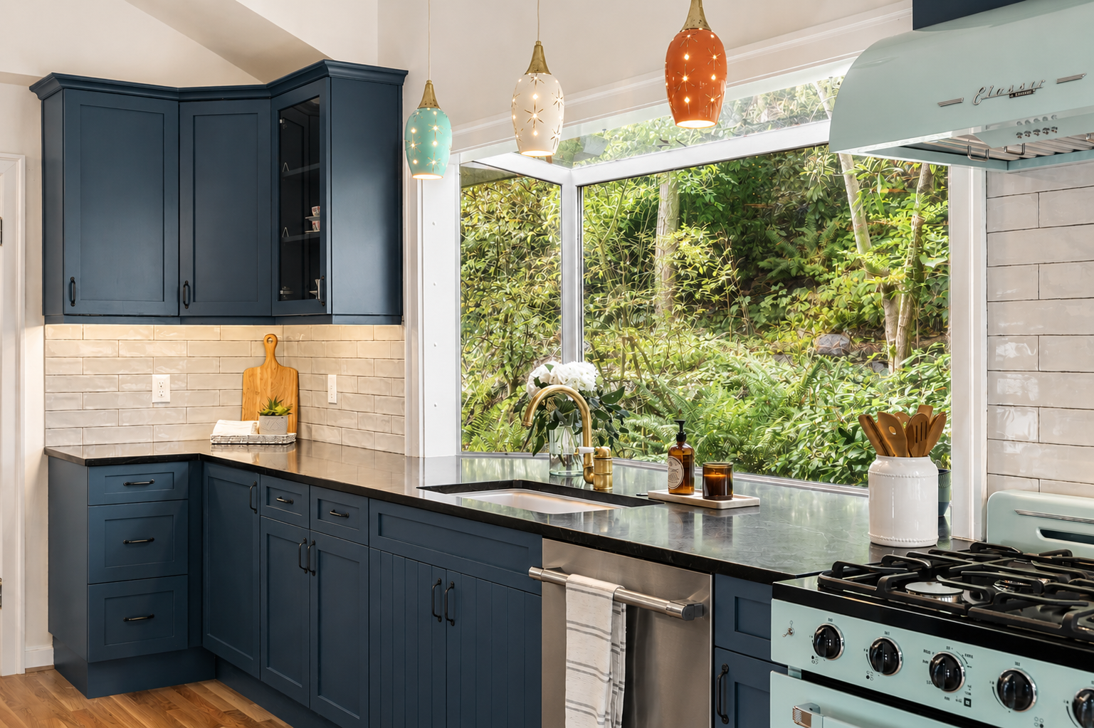 Teal blue kitchen cabinets with glass front and colorful pendant lights over garden window nook, 1905 Craftsman renovation