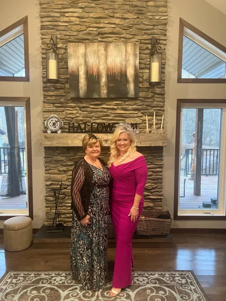 Owners of Stay549 standing in front of the fireplace