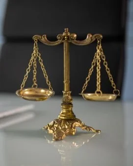 Gold balance scale with ornate base