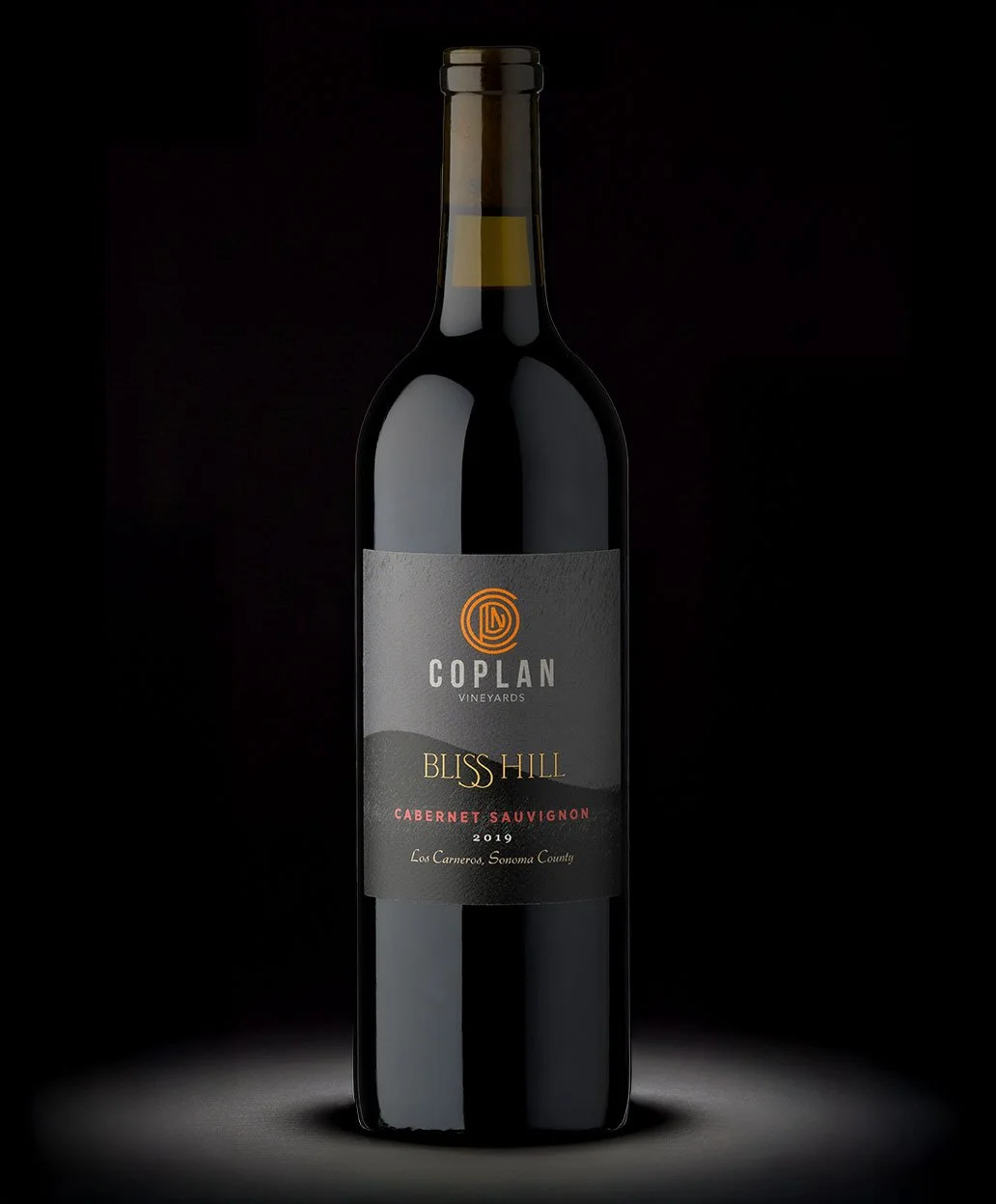 A bottle of Bliss Hill Cabernet Sauvignon 2019 wine from Coplan Vineyards, Los Carneros, Sonoma County, against a black background.
