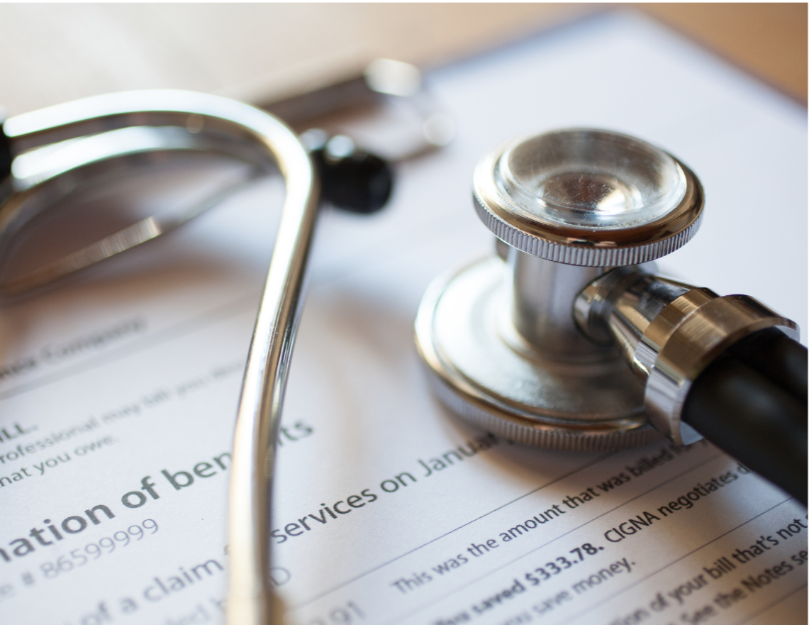 A stethoscope placed on a medical bill or document with text.