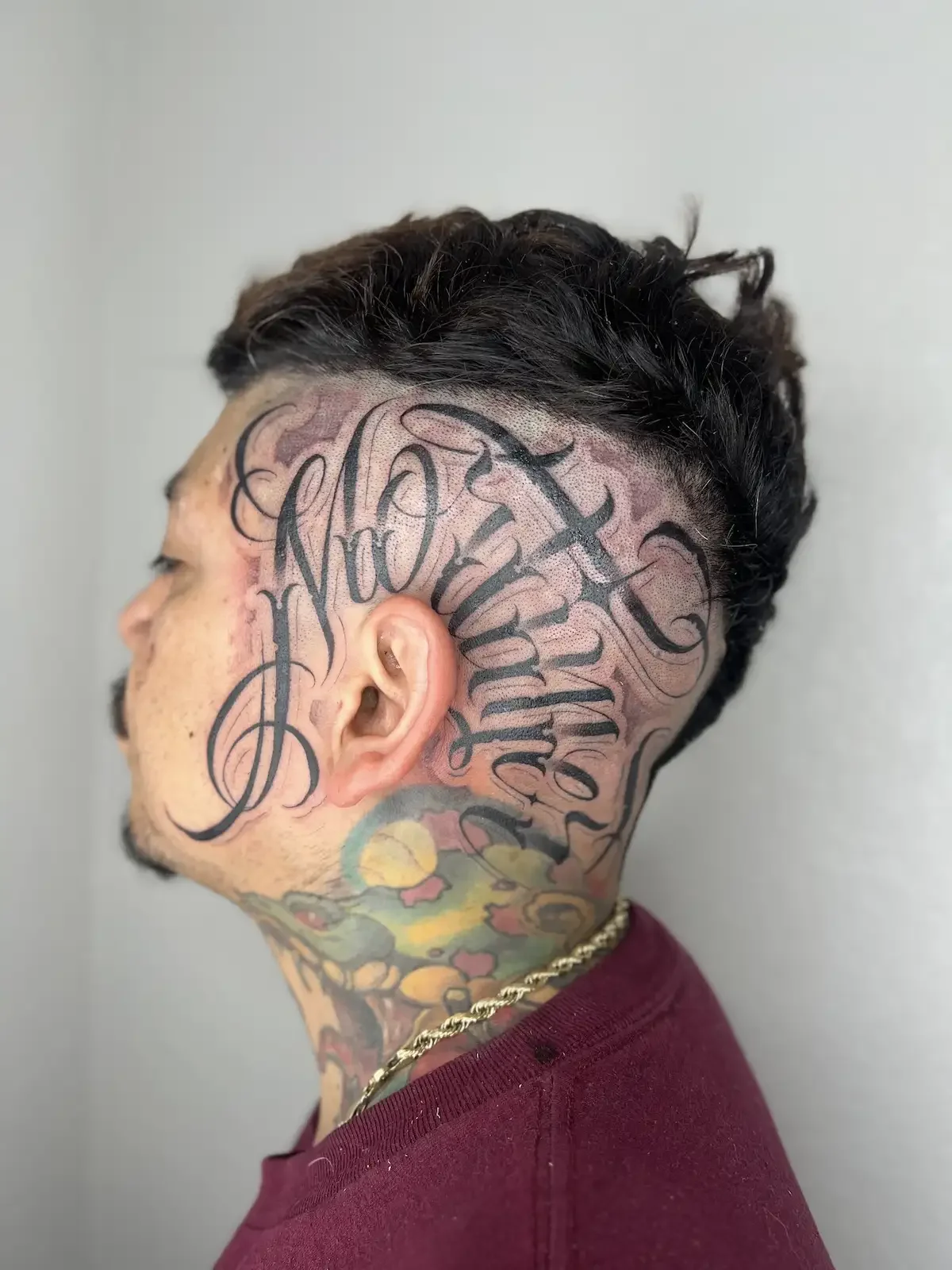Custom lettering script tattoo on the head by Austin tattoo artist Johny Vasquez — Mommasboy Tattoo