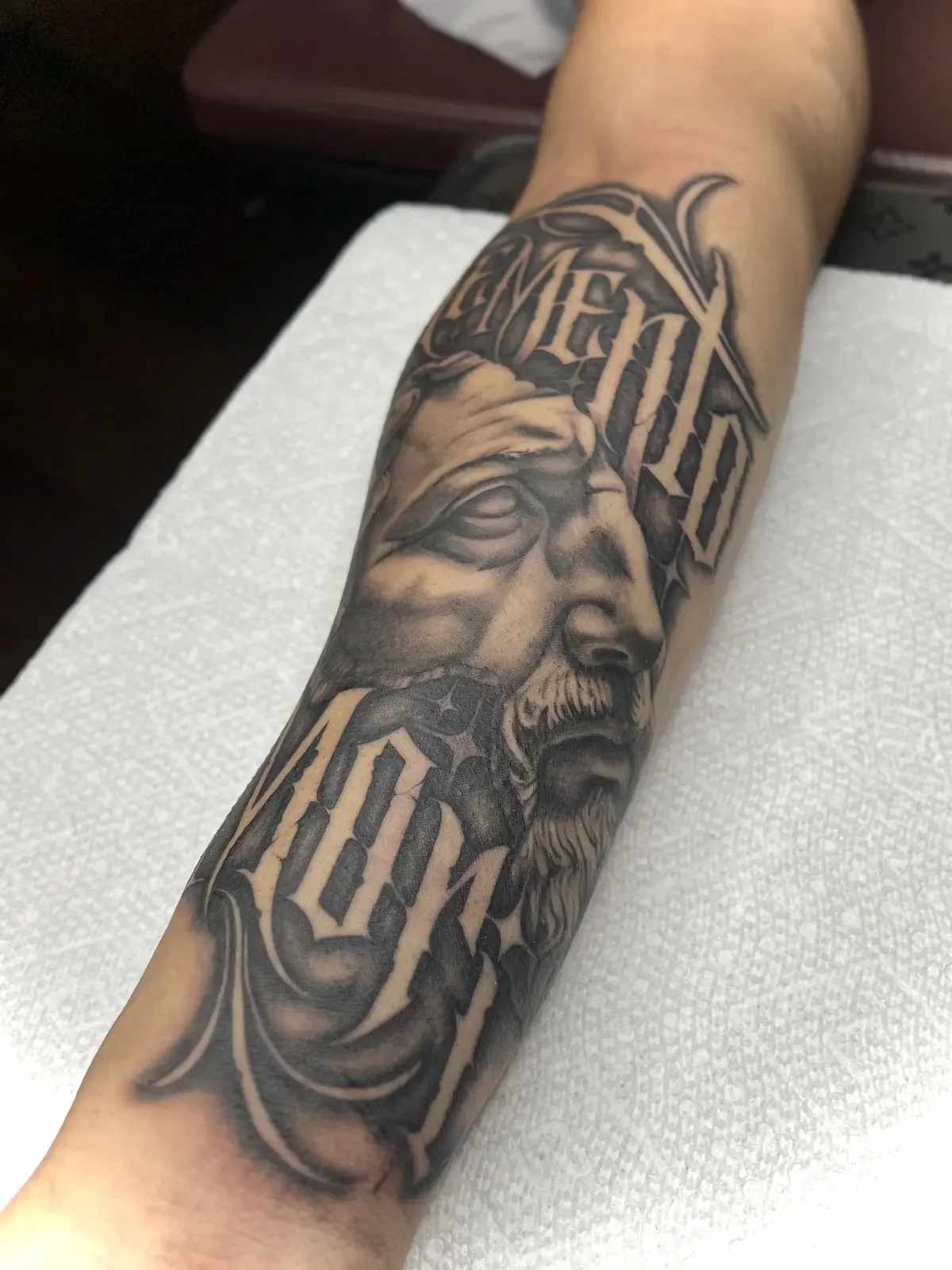 Black and grey realism portrait tattoo with custom lettering on forearm by Johny Vasquez — Mommasboy Tattoo Austin TX
