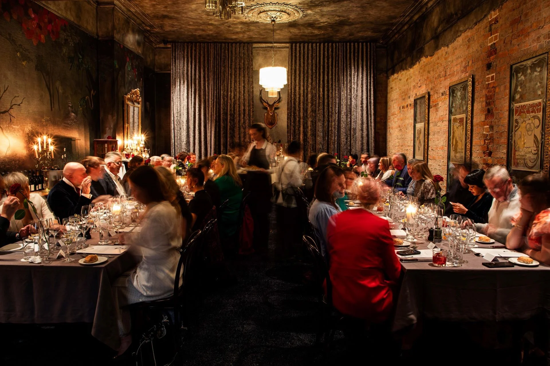 Smith St Bistrot's private dining room, La Vie en Rose with waitstaff serving and engaging with guests.
