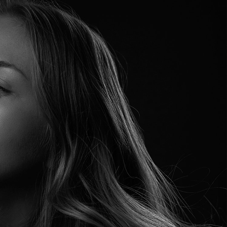 Close-up of a woman's face and hair in black and white
