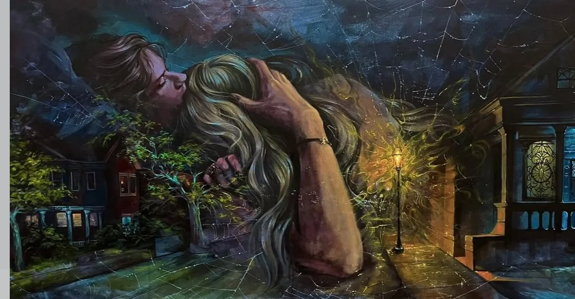 A mural of two women embracing, with one holding the other's head while they kiss. The scene is set outdoors at night with trees, a streetlamp, and houses in the background, surrounded by spider webs.