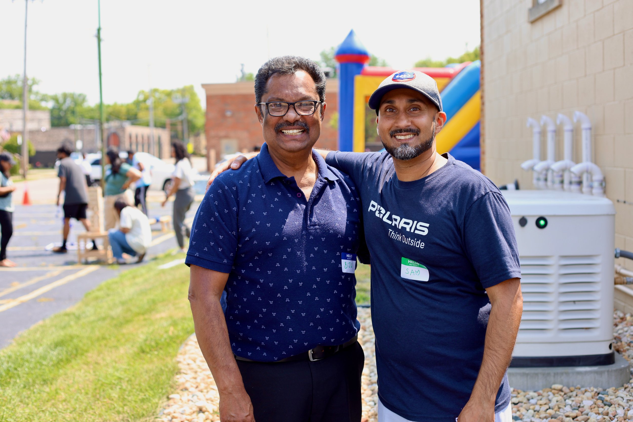 Two Indian men standing outside