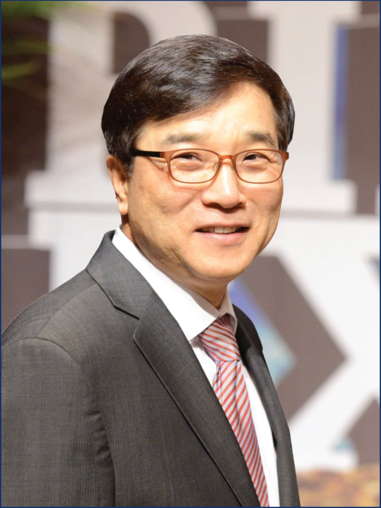 A portrait of a Korean man in a suit wearing glasses.