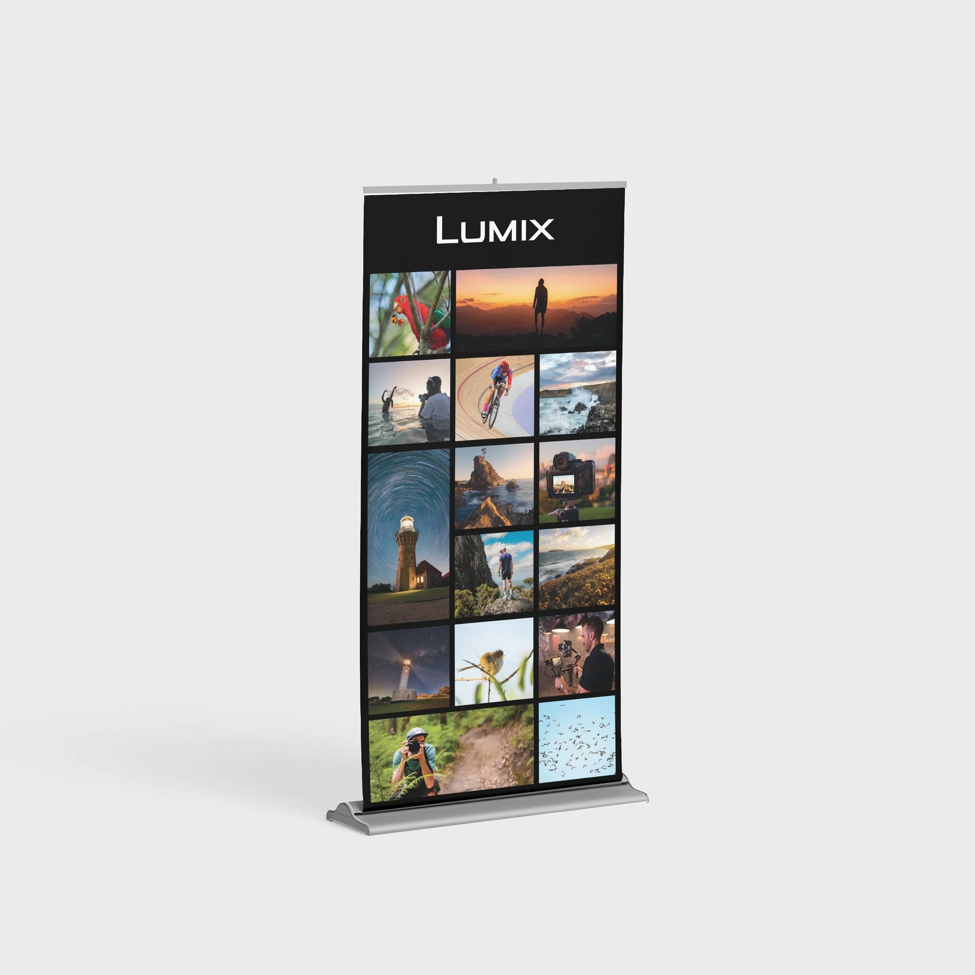 Vertical roll-up banner with the brand name 'LUMIX' at the top, featuring a collage of outdoor adventure and travel photographs, including landscapes, people hiking, cycling, and photography.