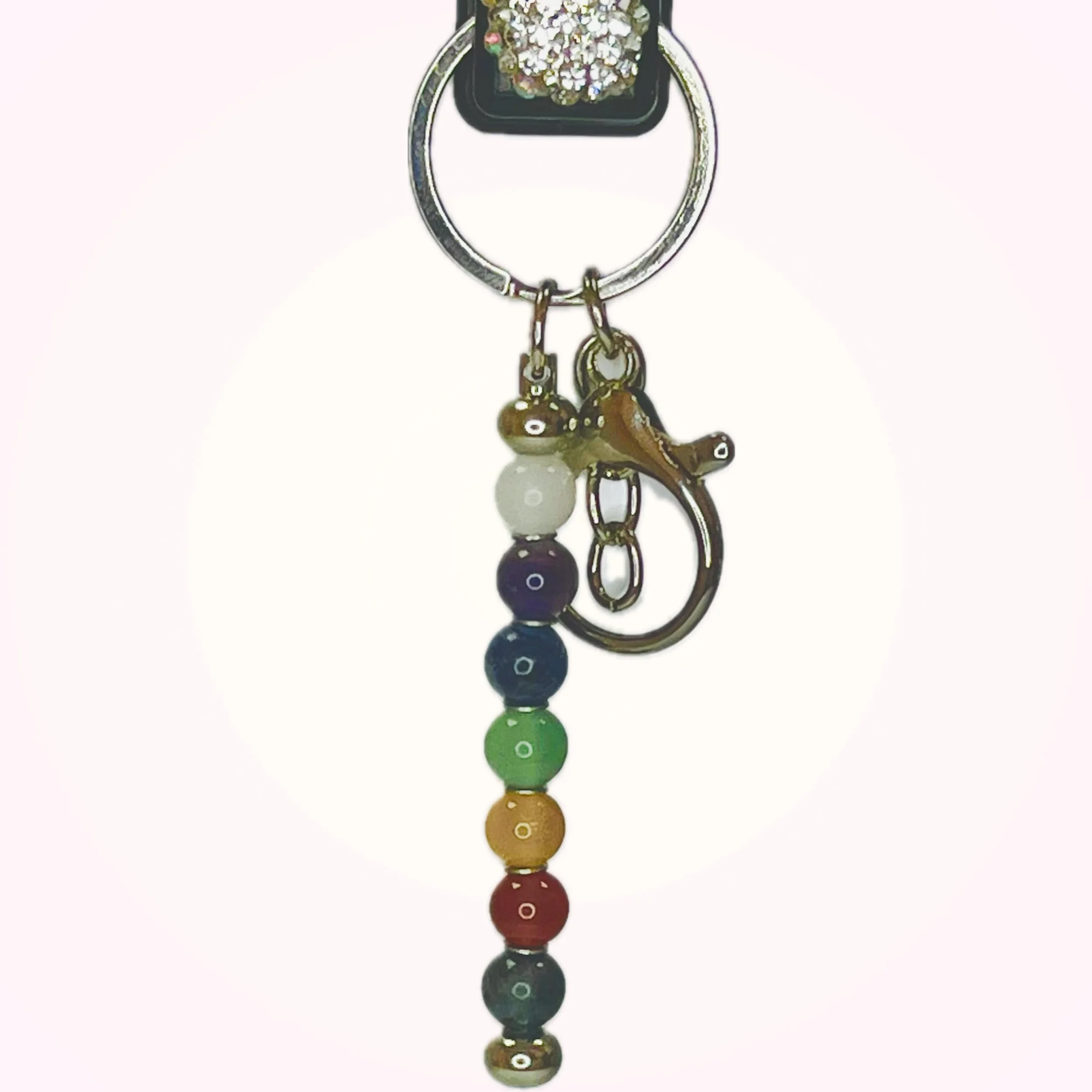 chakra keychain with 7 rainbow-colored crystal beads on a silver chain, representing the seven chakras.
