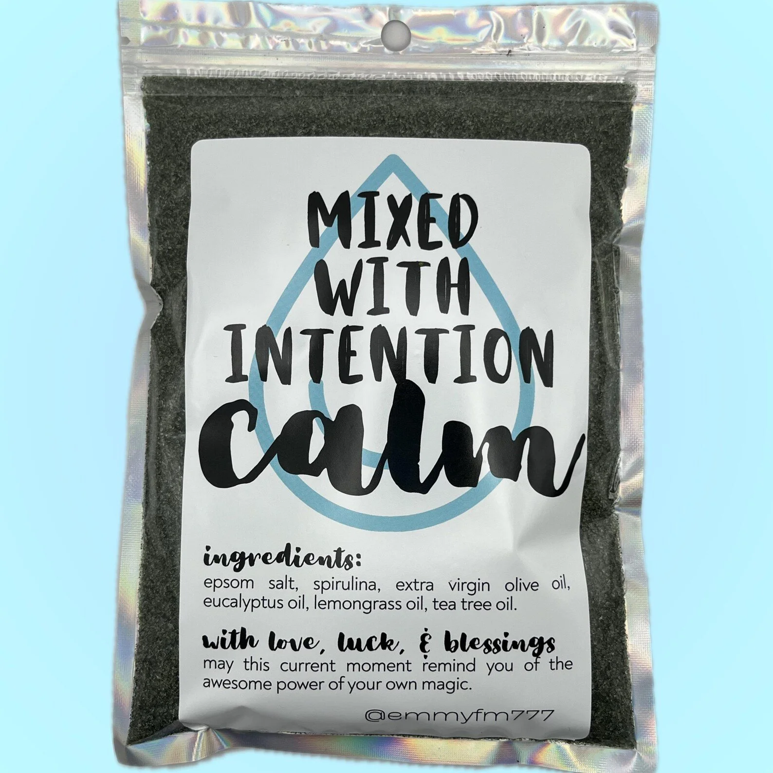 bath sachet labeled ‘mixed with intention calm’ featuring a soft blue background and a handwritten-style font. includes ingredients like epsom salt, spirulina, and essential oils.