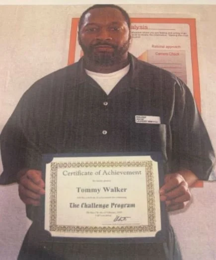 Man holding a Certificate of Achievement for Tommy Walker from The Challenge Program