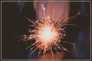 Close-up of a sparkler emitting bright sparks.