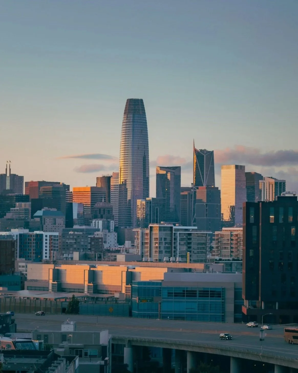 City skyline with modern skyscrapers, including the Salesforce Tower, during sunset in San Francisco.