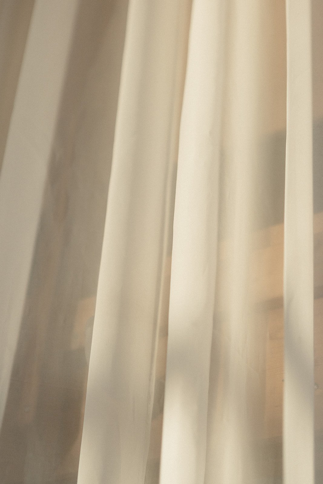 Close-up of white vertical blinds covering a window or door.
