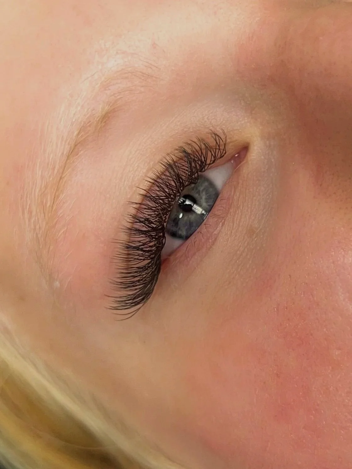 girl with hybrid lash extensions done in tulsa, oklahoma by wink&ink studio