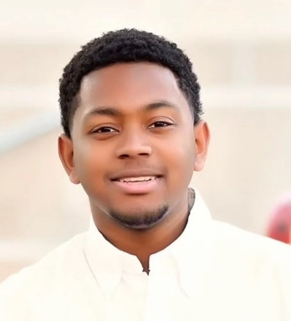 Young man in a white shirt smiling