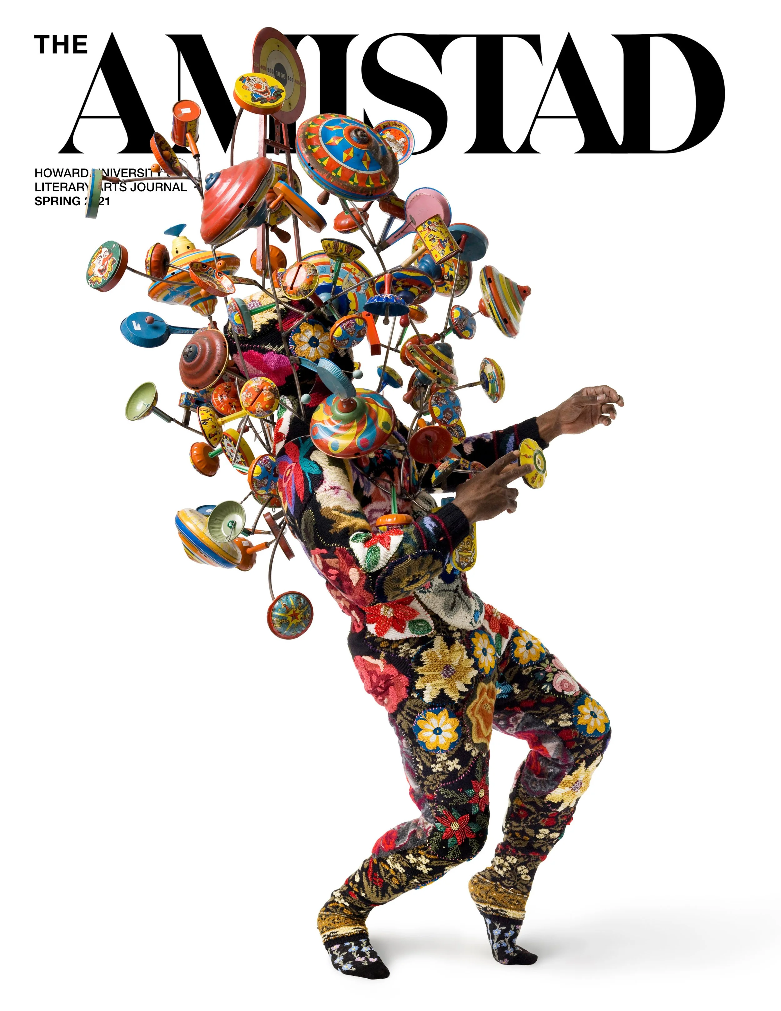 Cover of The Atlantic magazine featuring a person with a collage of colorful spinning tops and vintage toys on their head, wearing a floral patterned outfit.