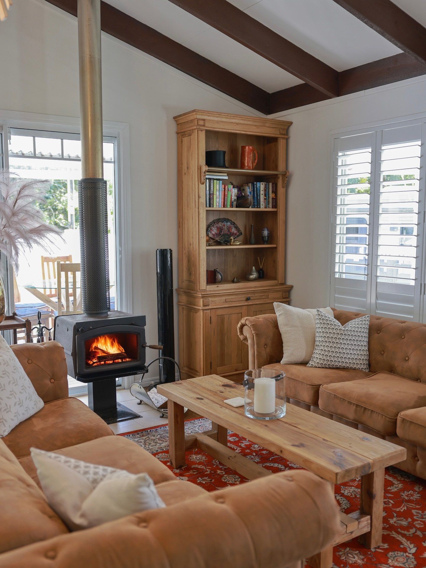 Step inside Firefly Cottage and feel an instant sense of calm.
The interiors blend farmhouse warmth and cottage charm &mdash; soft textures, timber accents, and sunlight streaming through windows overlooking the garden.

With a wood-burning fireplace